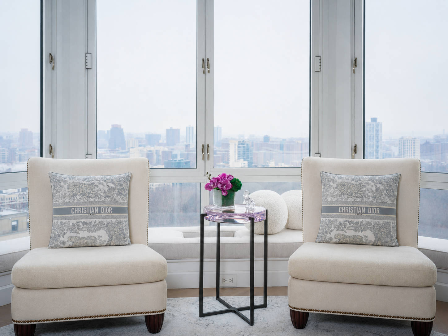 Twin slipper chairs by window with city view